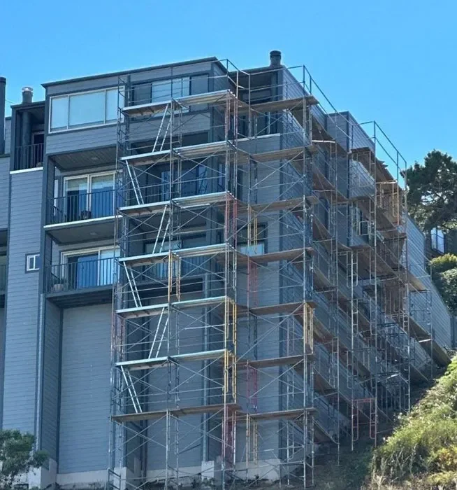 Construction worker inspecting Long Beach Scaffolding setup for safety and stability