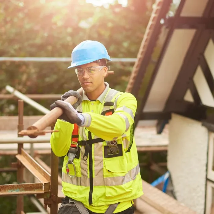 Construction worker using safety gear on scaffolding installation by Long Beach Scaffolding.